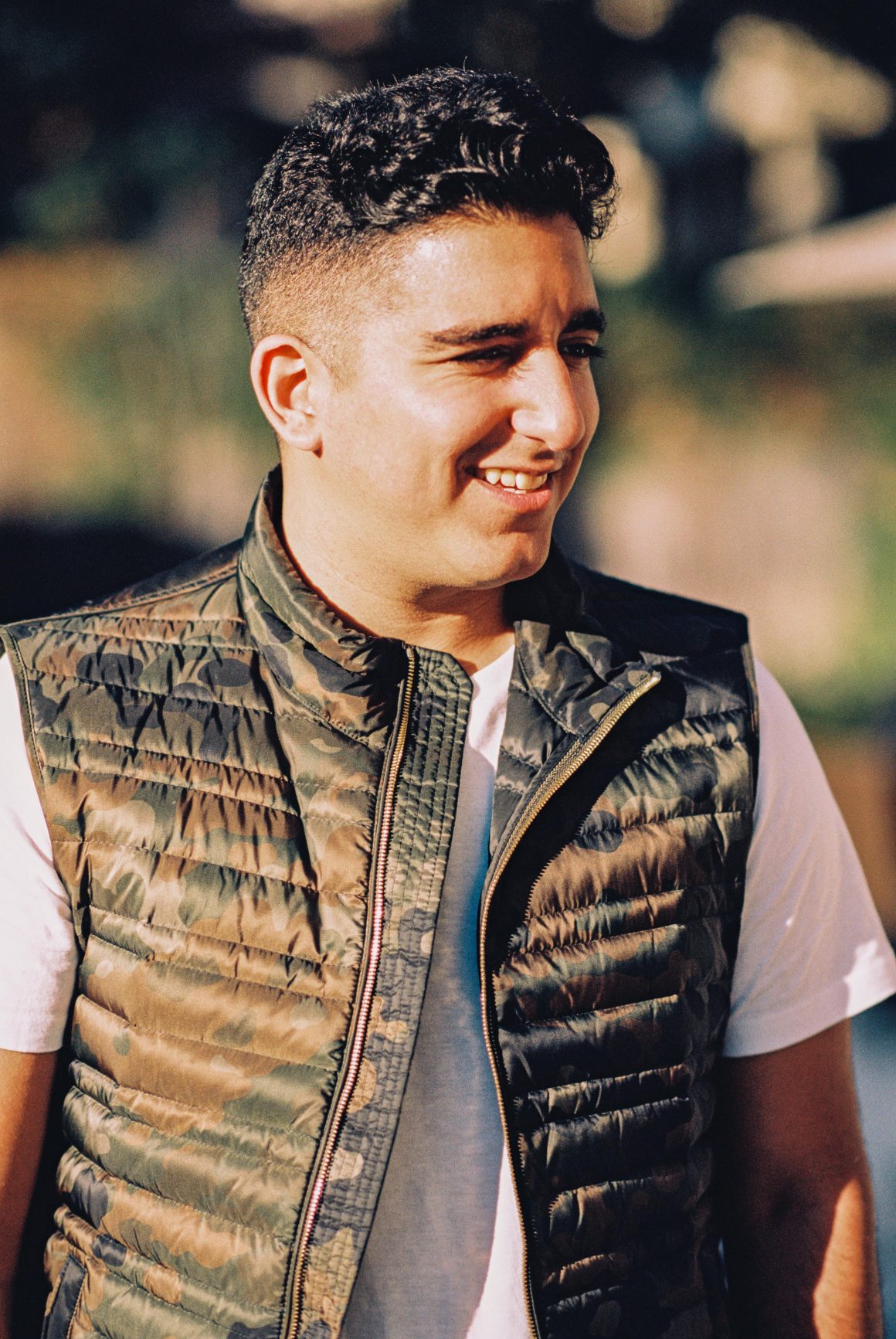 Young man with camouflage Burberry vest