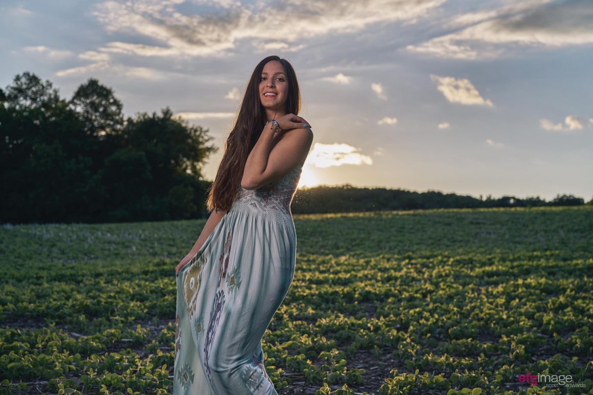 beautiful girl in field at sunset