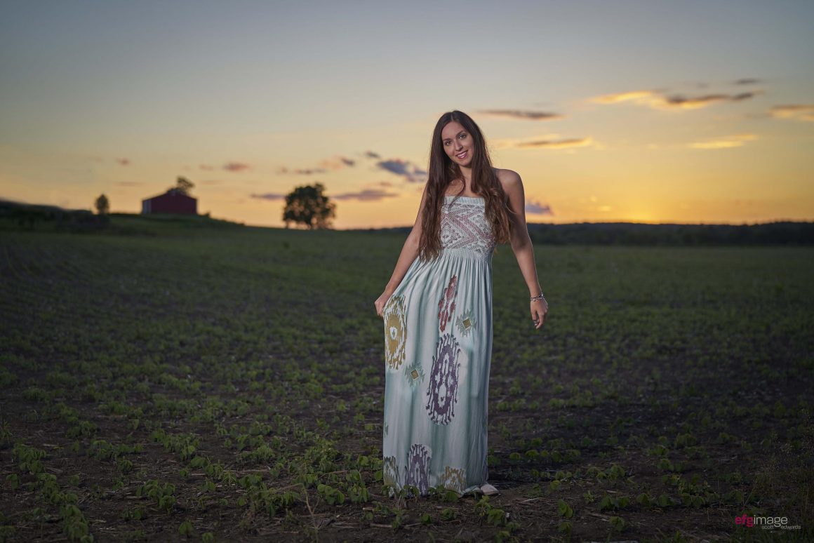 beautiful girl in field at dusk