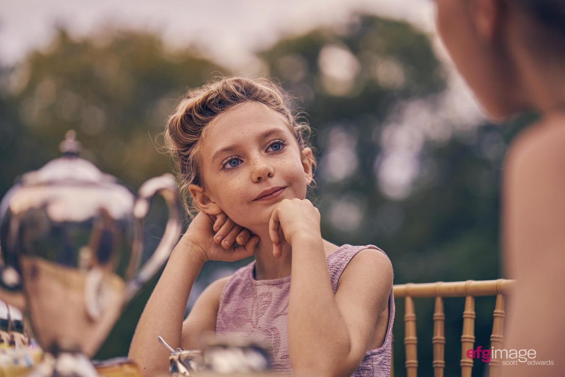 beautiful young girl at tea party is happy