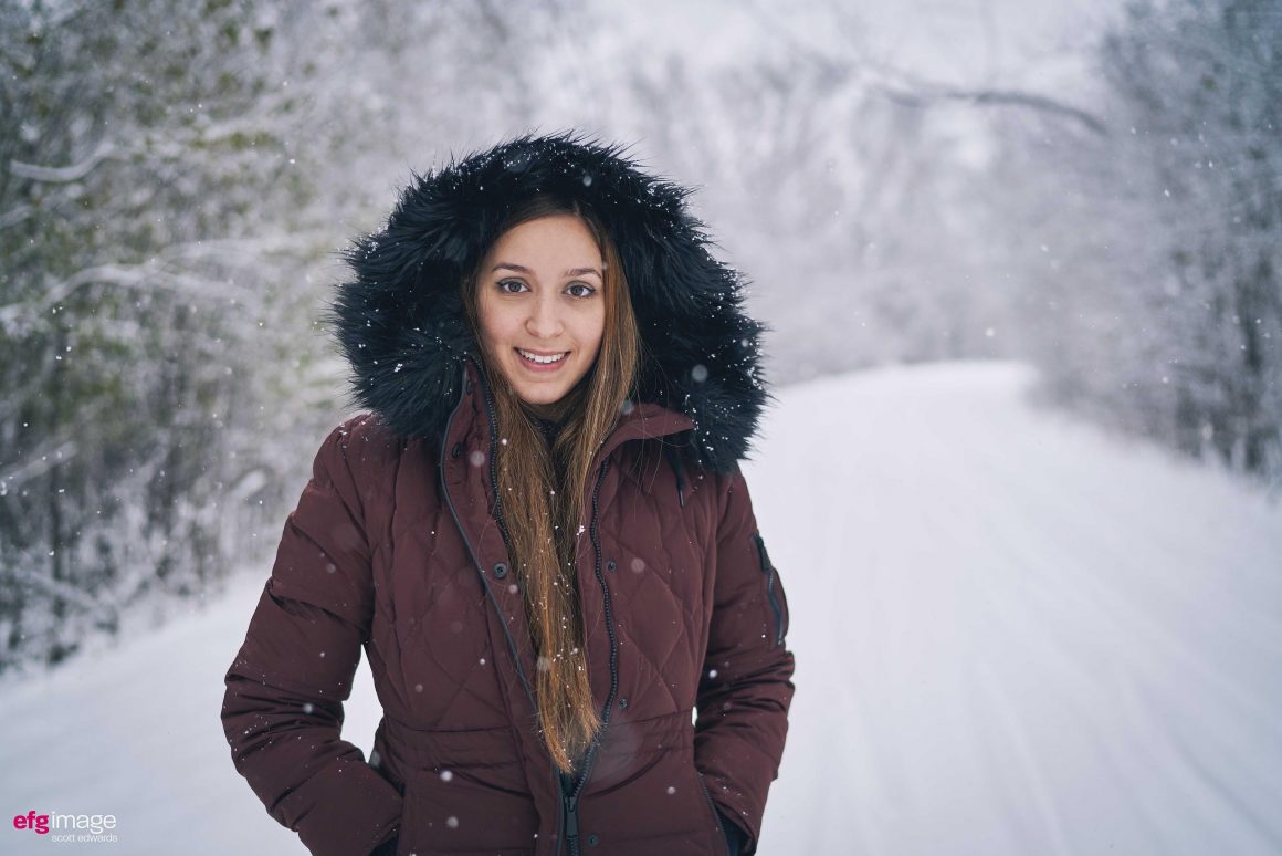 Pretty girl in forest during snowfall